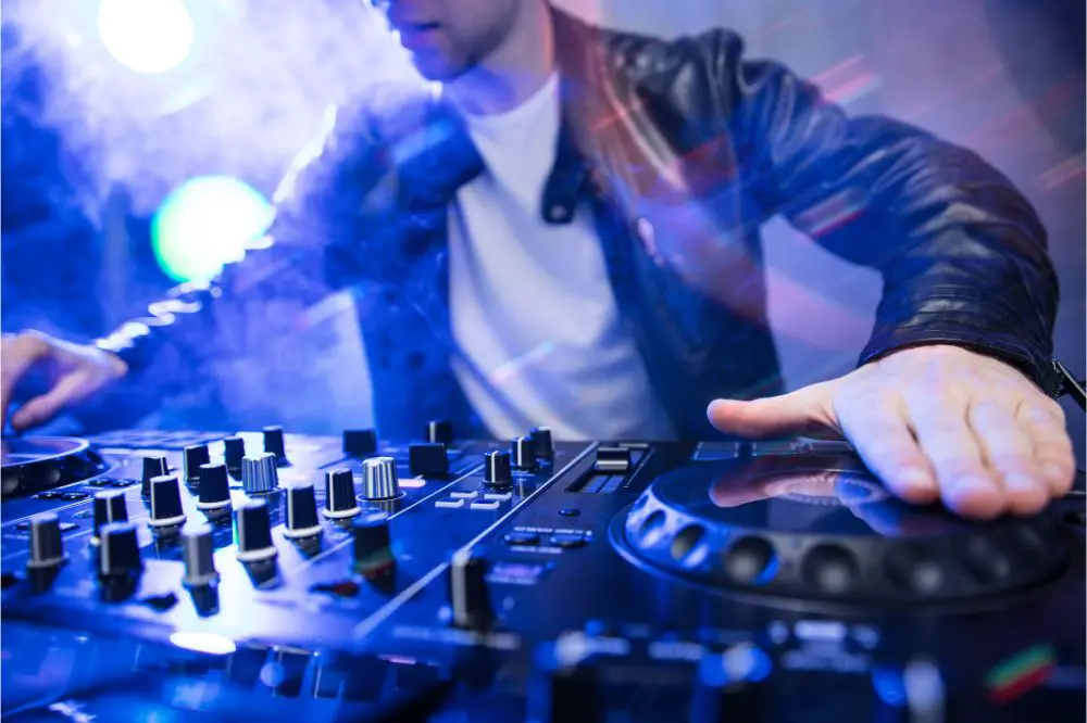 Dj mixing at party festival with red light and smoke 