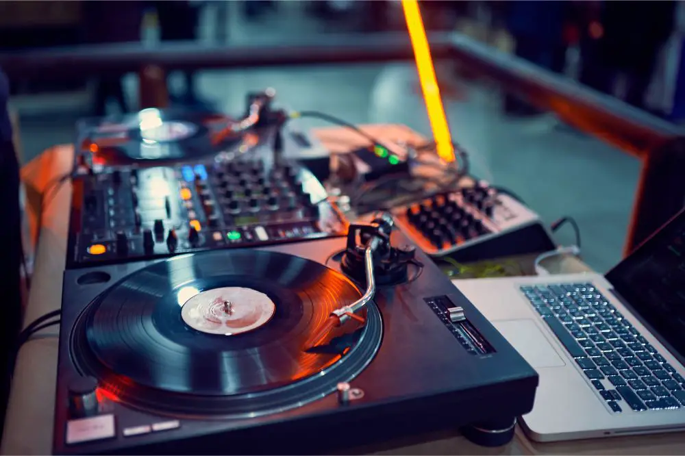 turntable, vinyl record at night club.