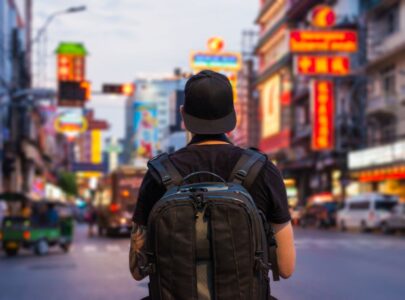 Man with backpack in the street of Chinatown